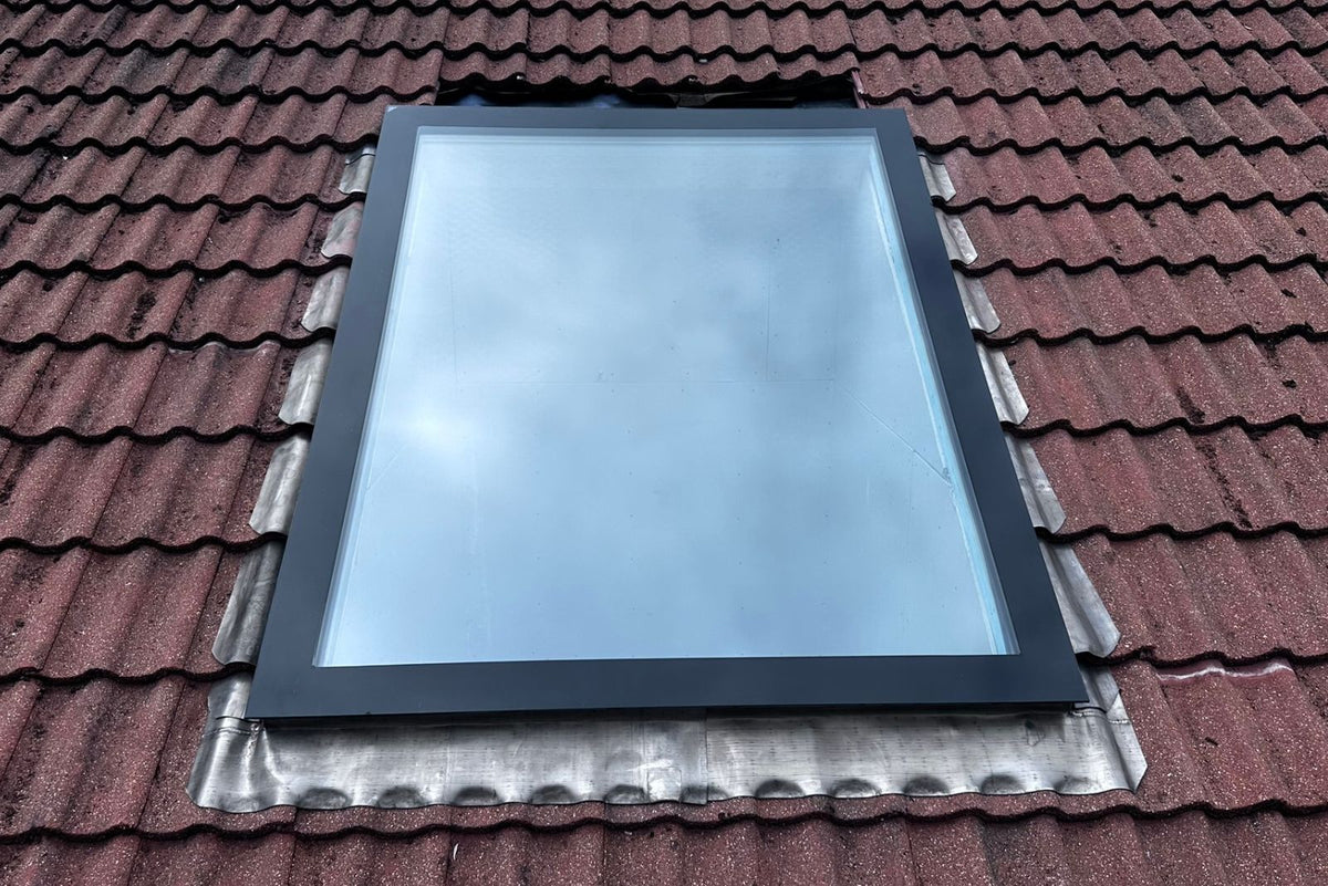 Rahmenloses Dachfenster im Schrägdach mit Ziegeldeckung und Eindeckrahmen